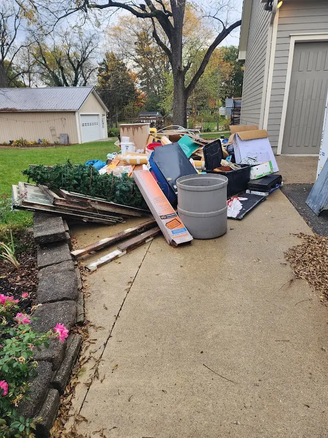 Dumpster being loaded with debris for 12 Yard Dumpster Rental in Cave Spring